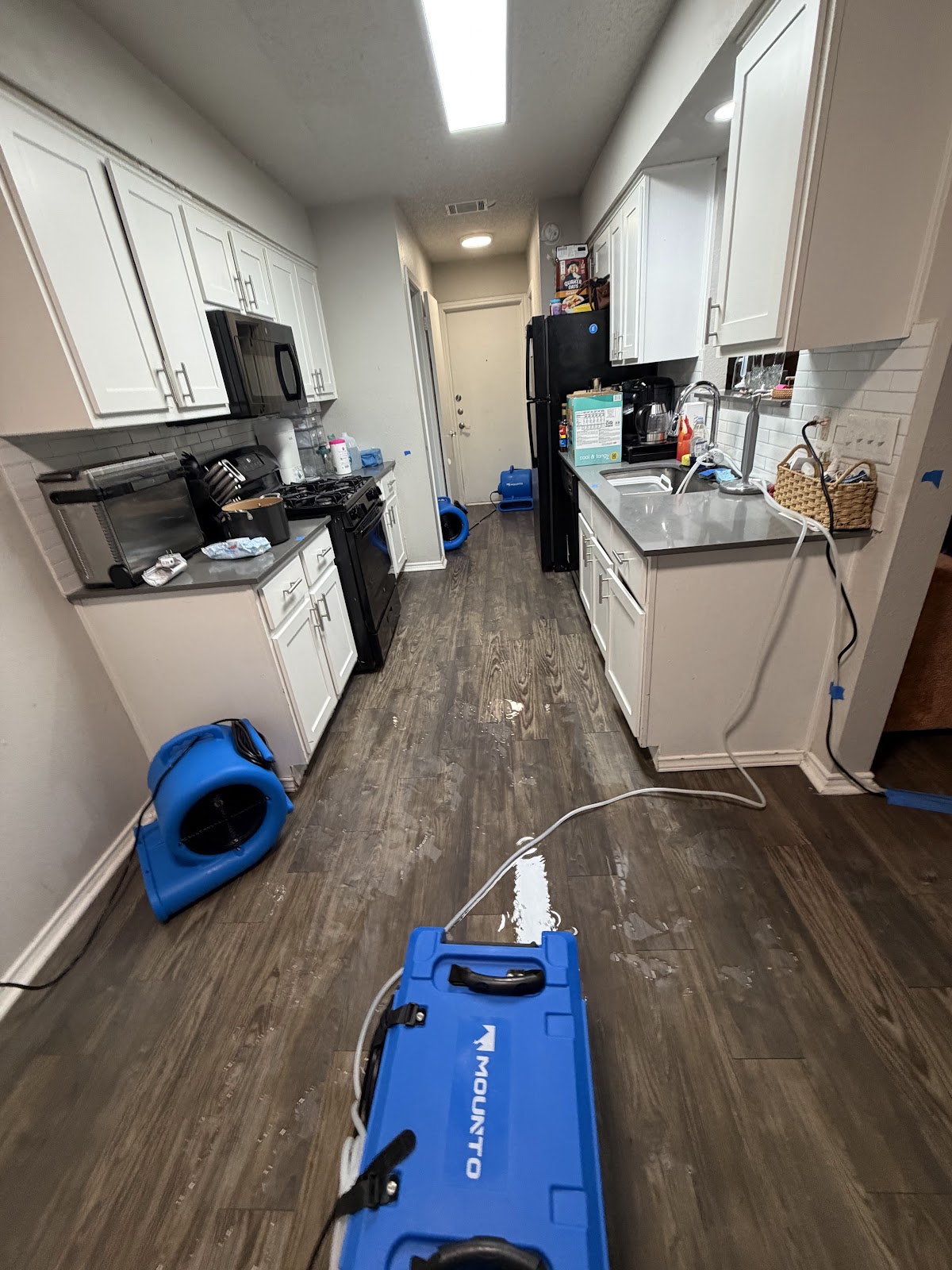 Water damage drying equipment in a kitchen